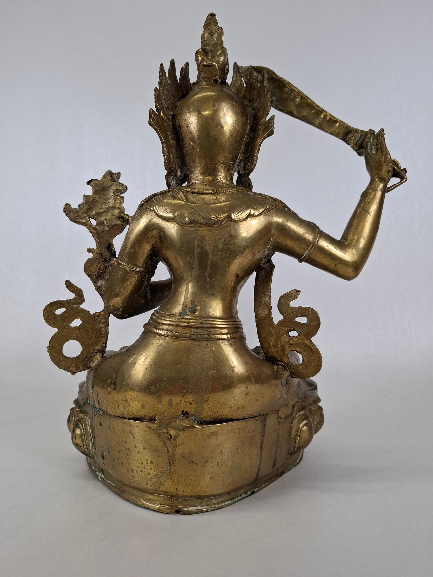 Backside f a brass Manjushri bodhisattva with detailed back ornaments