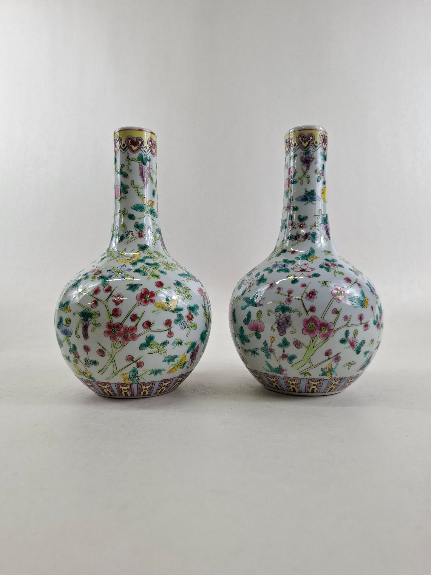 Set of 2 Chinese famille rose bottle vases decorated with flowers and butterflies // 20th century