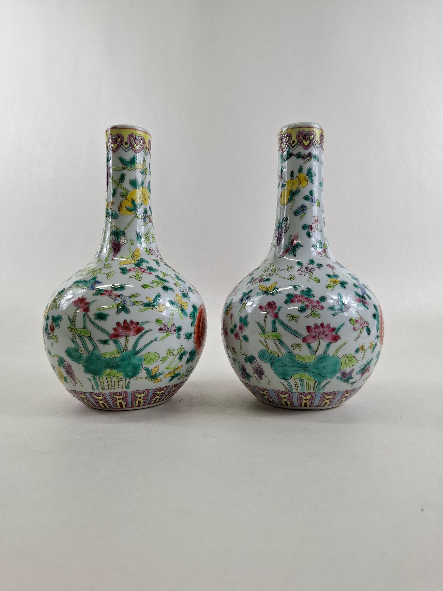 Set of 2 Chinese famille rose bottle vases decorated with flowers and butterflies // 20th century