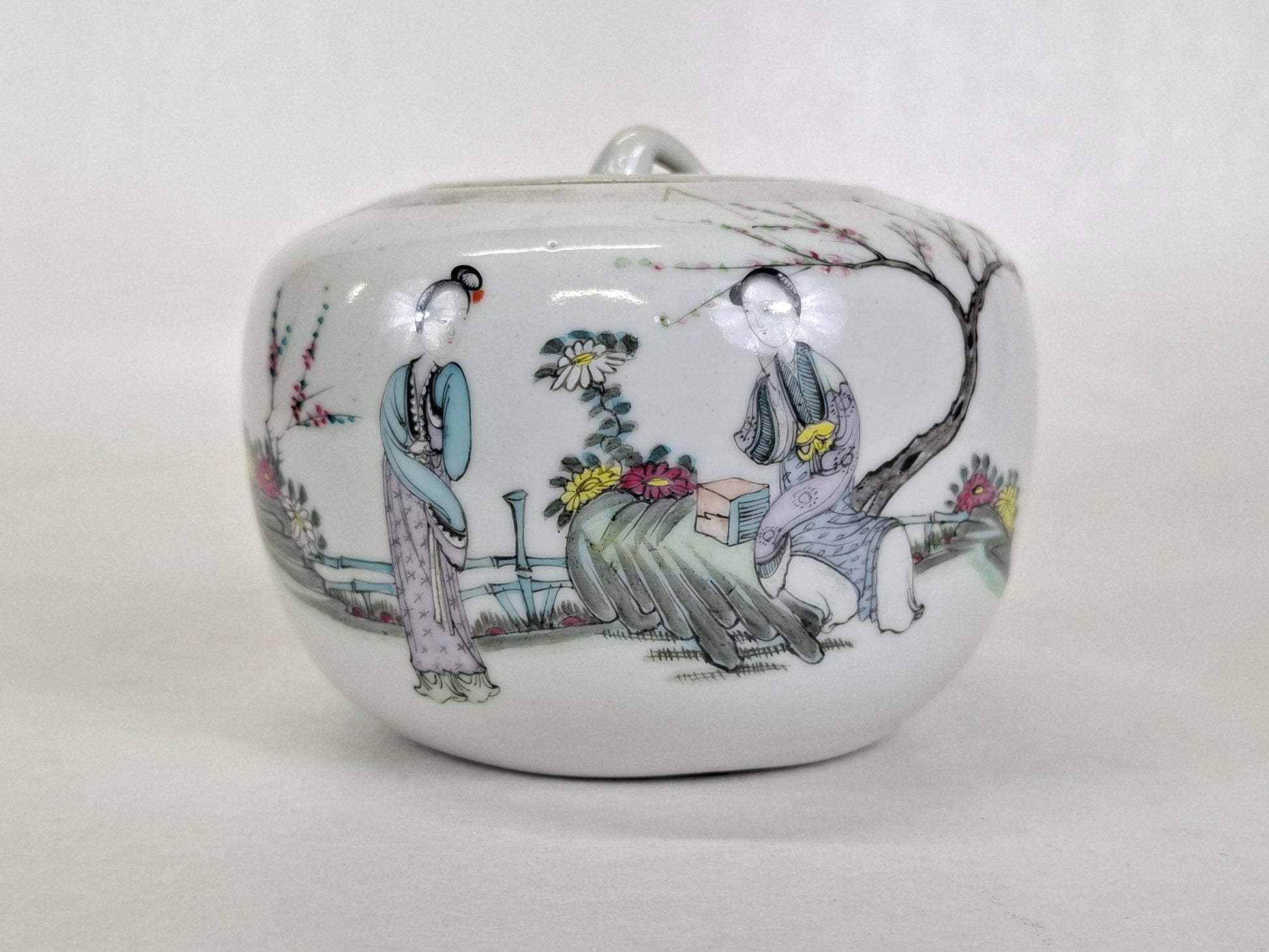 Hand painted Chinese porcelain lidded jar decorated with a garden scene including two Chinese ladies