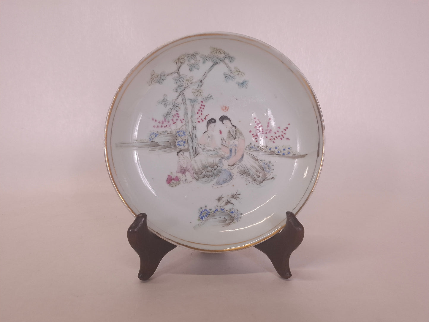 Antique Chinese handpainted sof color qianiang plate decorated with a garden scene including ladies and a child