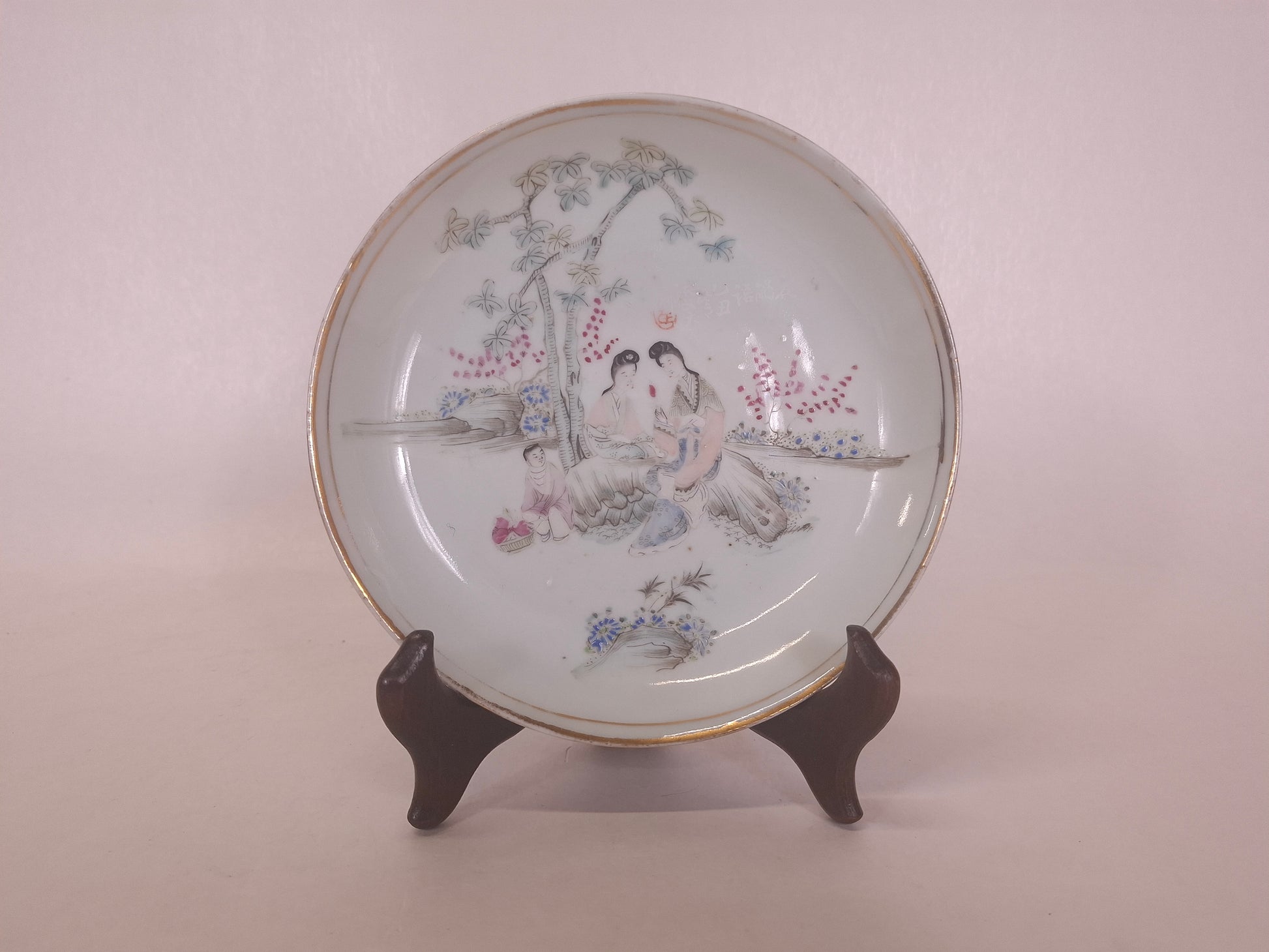 Antique Chinese handpainted sof color qianiang plate decorated with a garden scene including ladies and a child