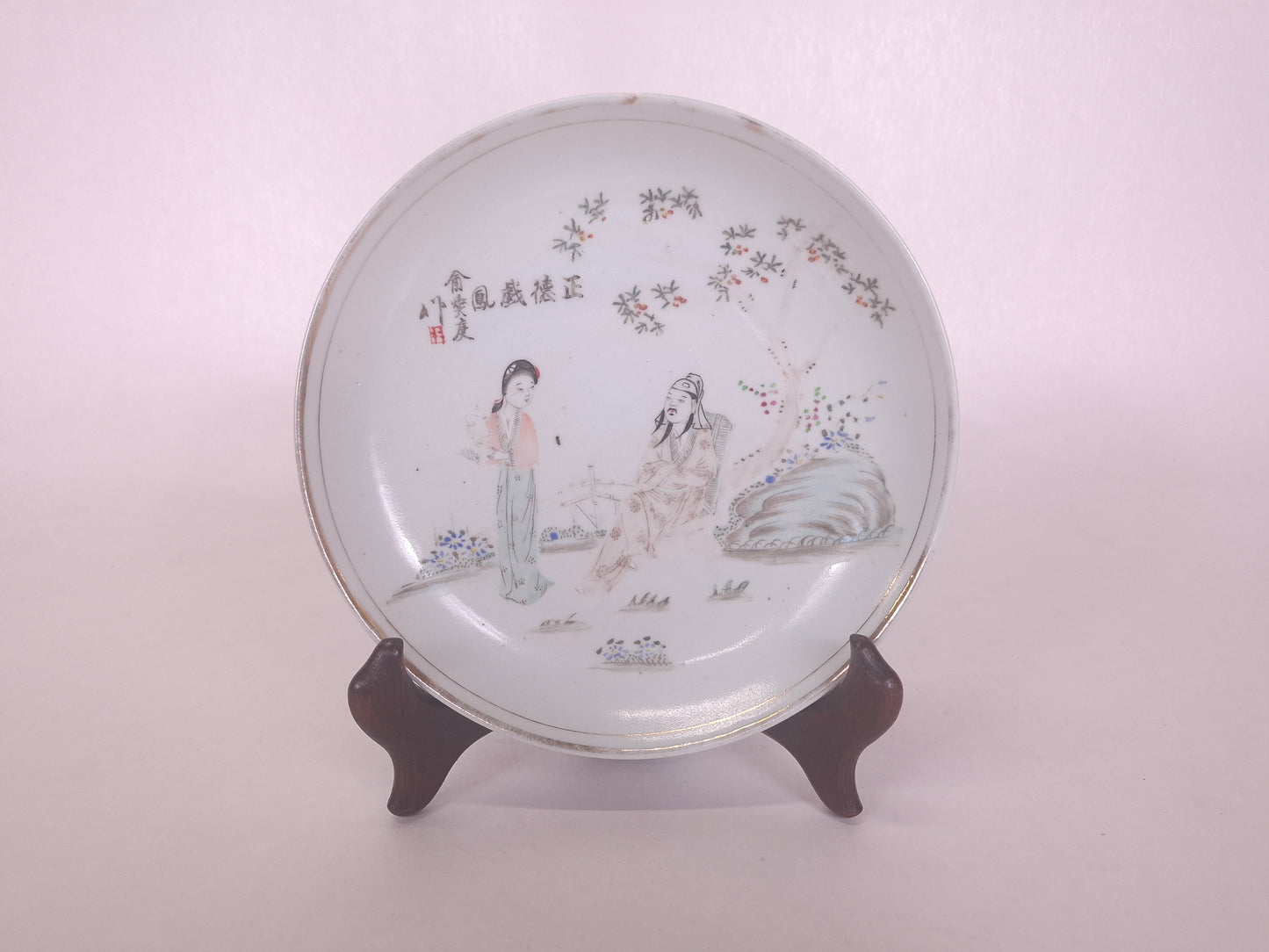 Antique Chinese handpainted qianjiang plate decorated with a garden scene including a Chinese lady and a sage