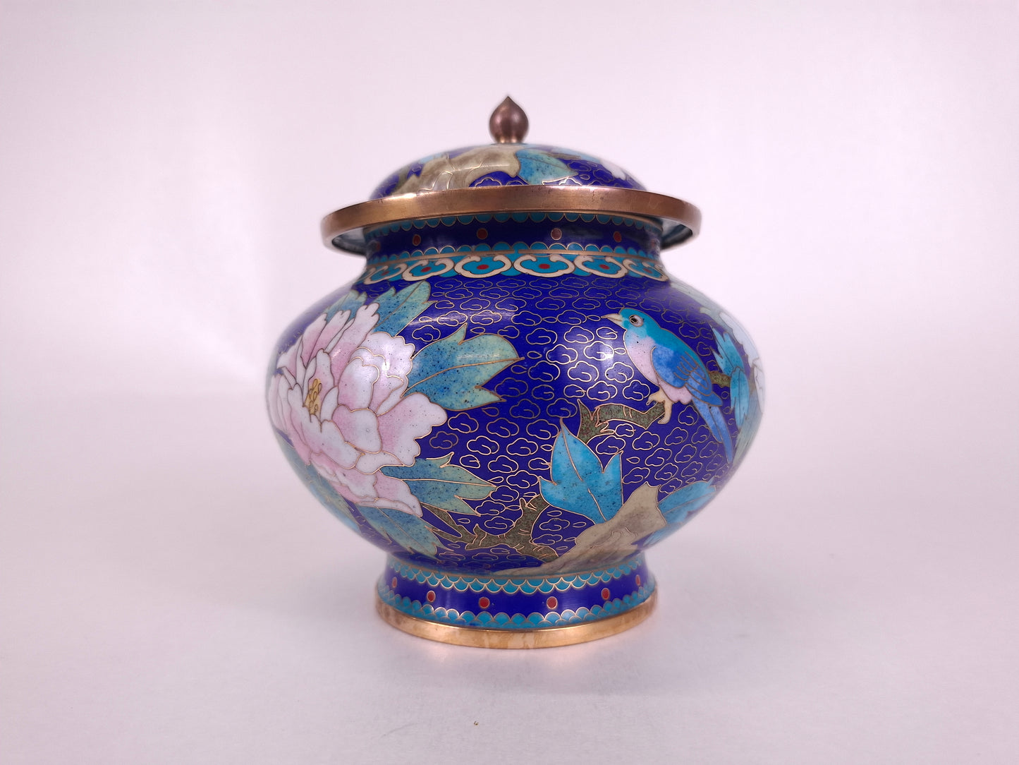 Handmade Chinese cloisonne lidded vase decorated with a bird and flowers on a blue background