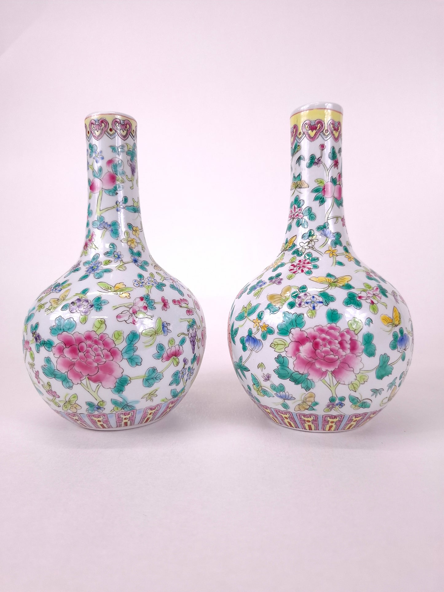 Set of 2 Chinese famille rose bottle vases decorated with flowers and butterflies // 20th century