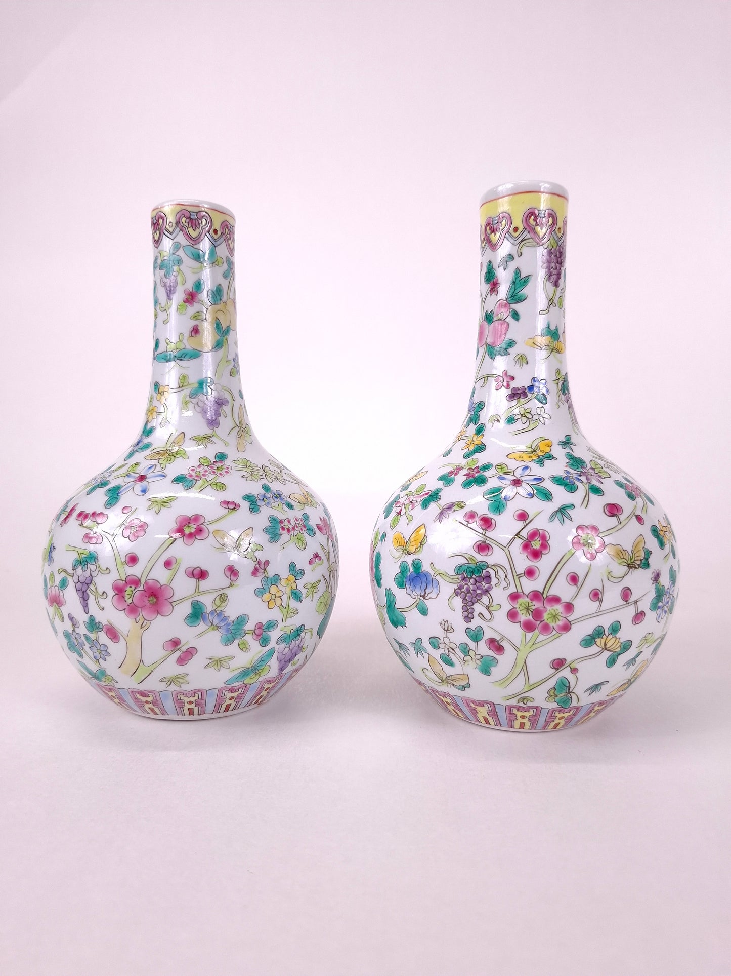 Set of 2 Chinese famille rose bottle vases decorated with flowers and butterflies // 20th century